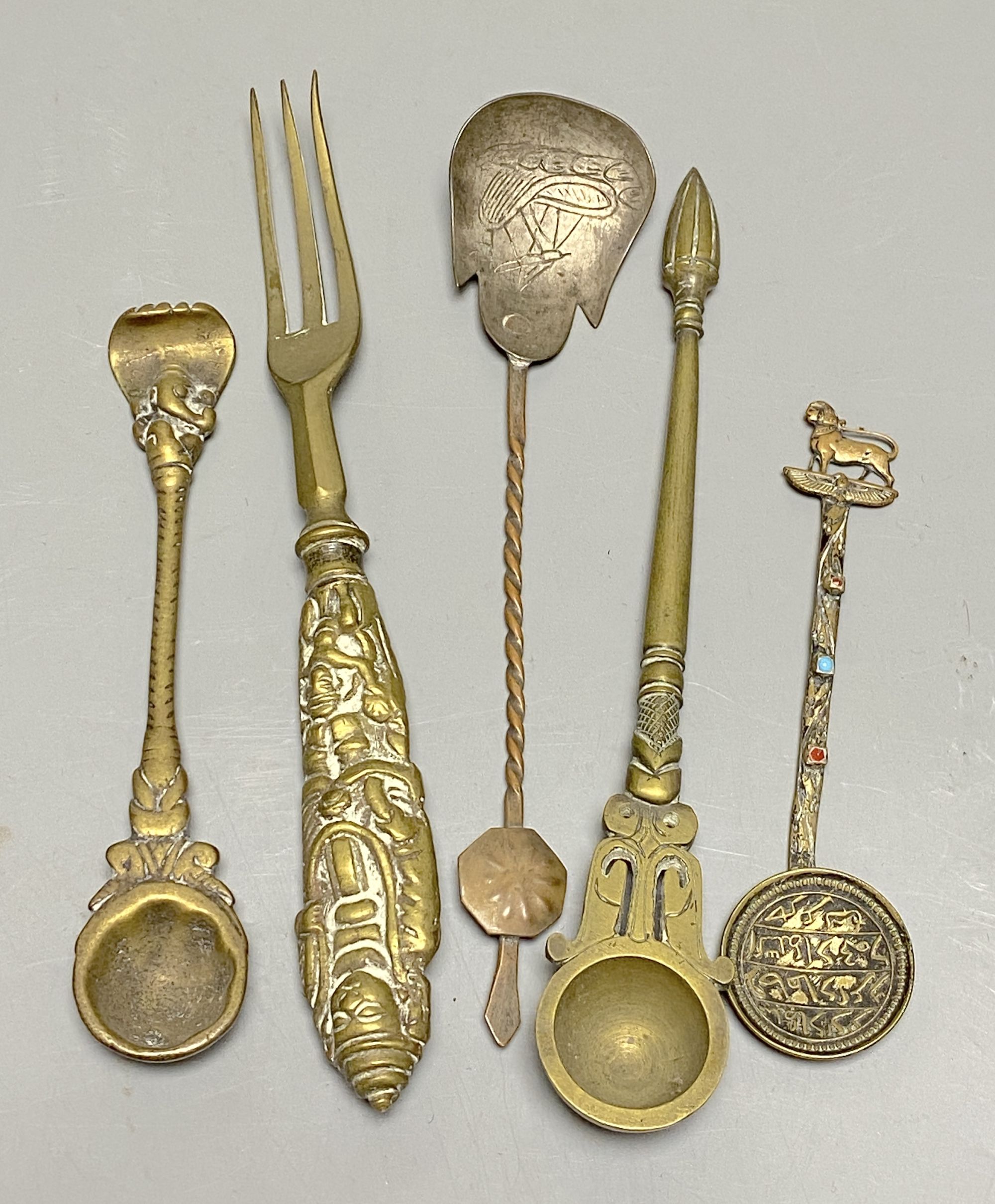 A group of Indian bronze spoons and a fork